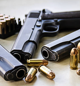 handguns, choosing the right handgun for your needs, handguns on a table, handguns for sale