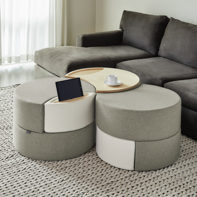 This image depicts a modern living room with a modular ottoman storage system serving as the focal point. The ottoman features clean lines and a sleek design, perfectly complementing the room’s modern aesthetic. Its modular design allows for flexible configuration, making it adaptable to various needs and spaces. The ottoman's storage capabilities are highlighted through its open compartments and lift-top lid, showcasing its functionality as a practical piece of furniture. The image effectively conveys the storage ottoman's versatility, suitability for various rooms like bedrooms, living rooms, and even office spaces, and its ability to enhance the modern feel of any environment.