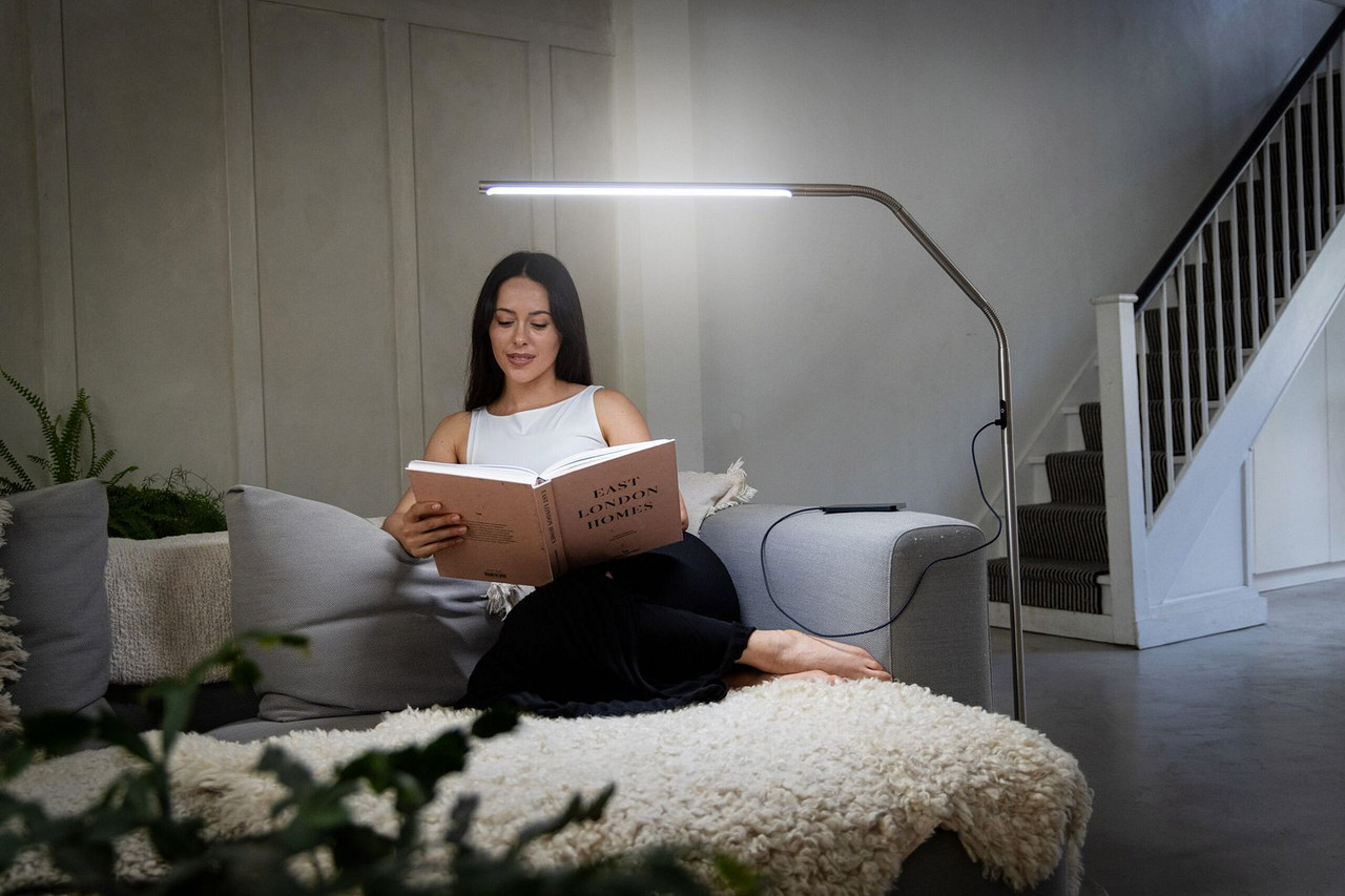 Vrouw leest een boek in de zetel