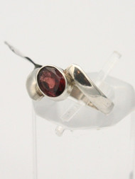 <p>Garnet faceted stone ring in 925 sterling silver. Size 8.0</p>