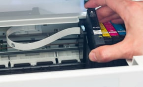 Inserting a standard yield HP toner cartridge into a laser printer.