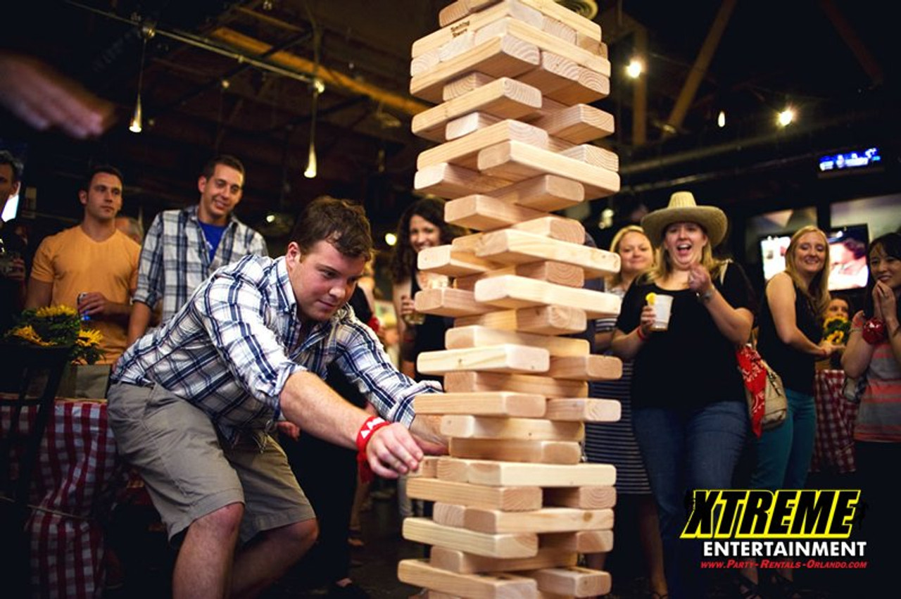 large jenga falls on kid