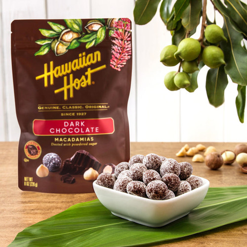 Hawaiian Host Paradise Collection - Dark Chocolate Covered Macadamias: the actual chocolates in a bowl in front of the pouch