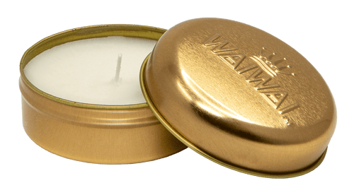 WaiWai Travel Tin Candle with tin opened to showcase soy wax candle inside.
