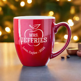 Personalized Teacher Appreciation coffee mug with handle to the right, personalized with your teacher's name in the apple outline and your special message shown on the table with a Christmas tree in the background. Personalized Teacher Appreciation coffee mug with handle to the right, personalized with your teacher's name in the apple outline and your special message shown on the table with a Christmas tree in the background.