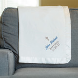 Personalized Microfleece Baptism Blanket for boy by Lifetime Creations customized with cross embroidery, baby's name and baptism date shown displayed on couch. Personalized Microfleece Baptism Blanket for boy by Lifetime Creations customized with cross embroidery, baby's name and baptism date shown displayed on couch.