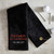 Custom Golf Towel in black embroidered with Father of the Groom in red thread and the wedding date in white thread.
