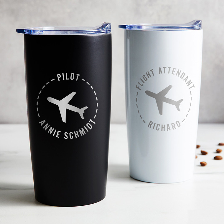 Personalized Pilot or Flight Attendant stainless steel coffee tumbler in black or white laser engraved with airplane design and your name and title, displayed on table.