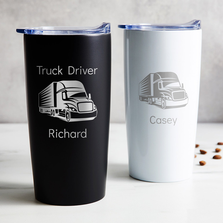 Personalized Truck Driver stainless steel coffee tumbler in black or white laser engraved with semi truck trailer design and your name, displayed on table.