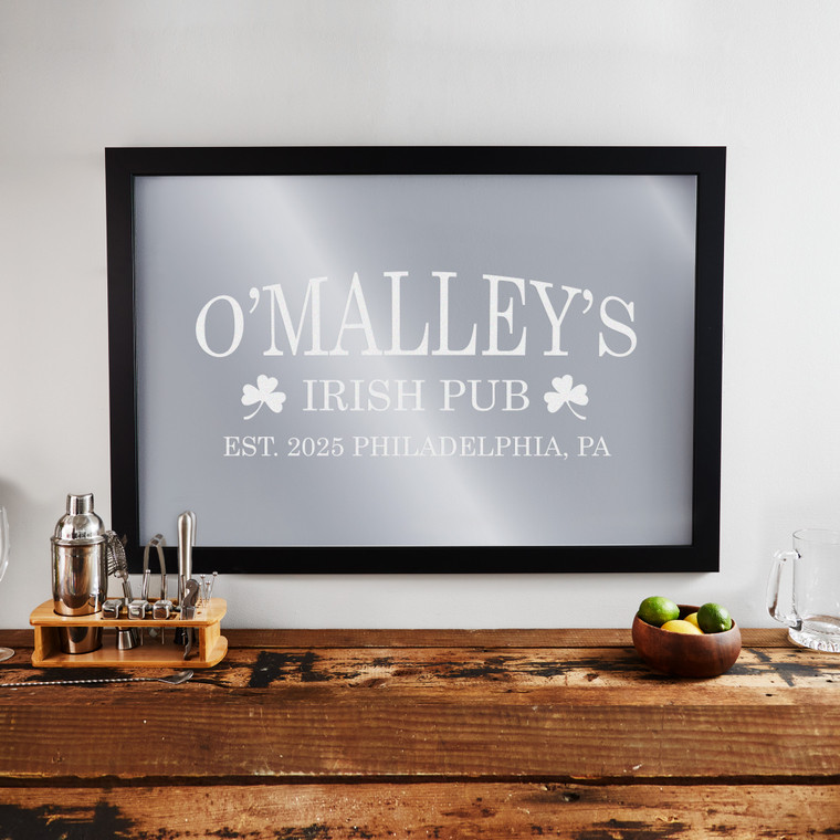 Personalized Irish Pub Bar Mirror with black frame laser engraved with your custom text and shamrocks, displayed hanging on wall. Personalized Irish Pub Bar Mirror with black frame laser engraved with your custom text and shamrocks, displayed hanging on wall.