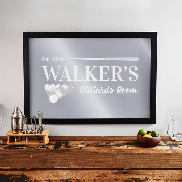 Personalized Billiards Bar Mirror with black frame laser engraved with your custom text and pool cue and billiards balls, displayed hanging on wall.