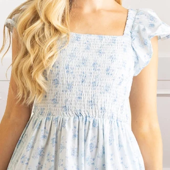 Close-up of blue floral cotton maxi dress with smocked bodice and flutter sleeve detail