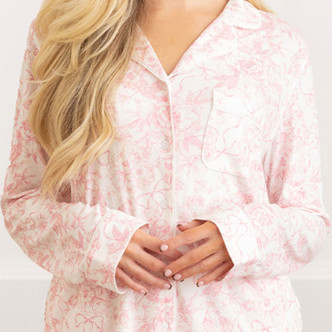 Close-up of pink bow toile pajama top with button-down front and soft fabric detail