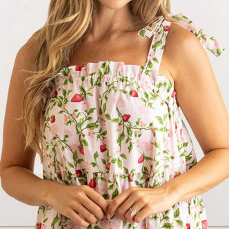 Close-up of botanical berry cotton fabric with strawberry bud print and adjustable tie strap detail