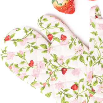 Close-up of botanical berry oven mitt with pink floral, green vines and strawberry print