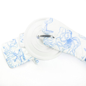 Pair of oven mitts with blue ocean-inspired pattern featuring shells and sea life (angled view)