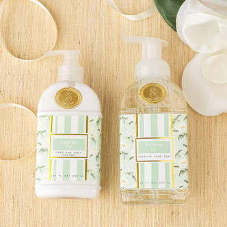 Flat lay of magnolia fig foaming hand soap with mint packaging and green botanical design