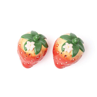 Pair of strawberry-shaped salt and pepper shakers with glossy finish and hand-painted detail (product view)