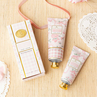 Flat lay of vanilla blush hand cream with pastel pink packaging and matching tube detail