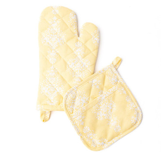 Pair of yellow oven mitt and pot holder with golden damask pattern and quilted cotton texture (top view)