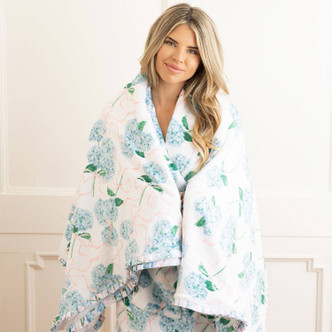 8 Oak Lane hydrangea ribbons luxe throw blanket 56 x 60 inches with blue floral print and pink ribbon detail (lifestyle view)