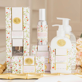 Styled bathroom scene with botanical berry bar soap and coordinating bath products in pink floral packaging