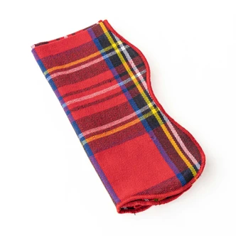 Red tartan plaid cotton dinner napkin tied with a red ribbon (alternate angle)
