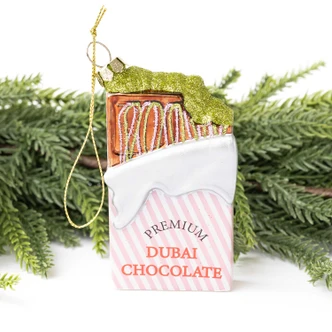 Glass Christmas ornament shaped like a Dubai chocolate bar with a pistachio-green glitter drizzle (alternate angle)