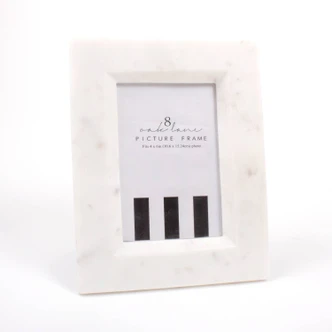 White marble picture frame with subtle natural veining, styled with a palm leaf (alternate angle)