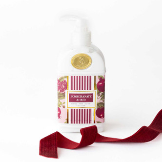 Pomegranate & Oud hand and body lotion bottle with a pink pomegranate print