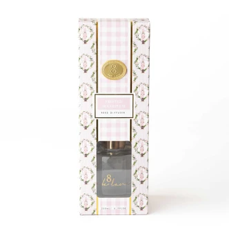 Frosted Sugarplum reed diffuser with gold reed sticks in a pink gingham and floral box (alternate angle)