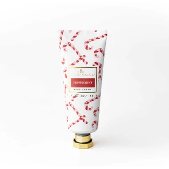 Peppermint Candy Cane travel hand cream tube in a red and gold lattice print (alternate angle)