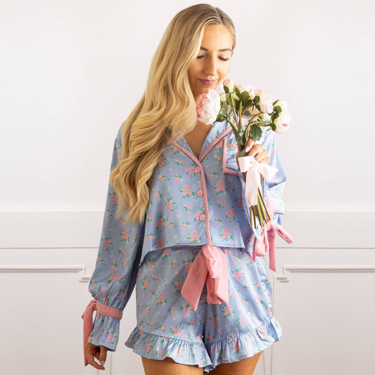 8 Oak Lane women’s satin pajama set in blue bud floral print with long sleeve button-down top and ruffle trim shorts (front view)