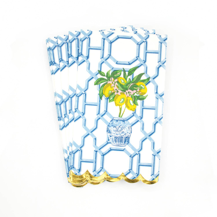 Folded paper guest towel with a lemon tree and blue trellis print, finished with gold foil scalloped edge