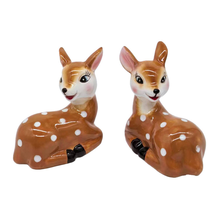 Two ceramic doe-shaped salt and pepper shakers with white spots and black hooves