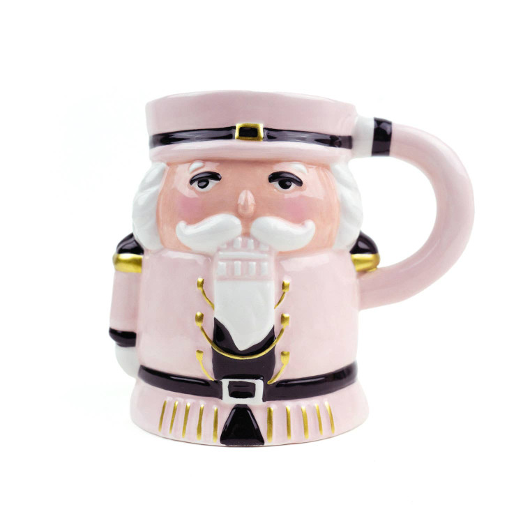 Pink ceramic mug shaped like a dimensional nutcracker with gold trim