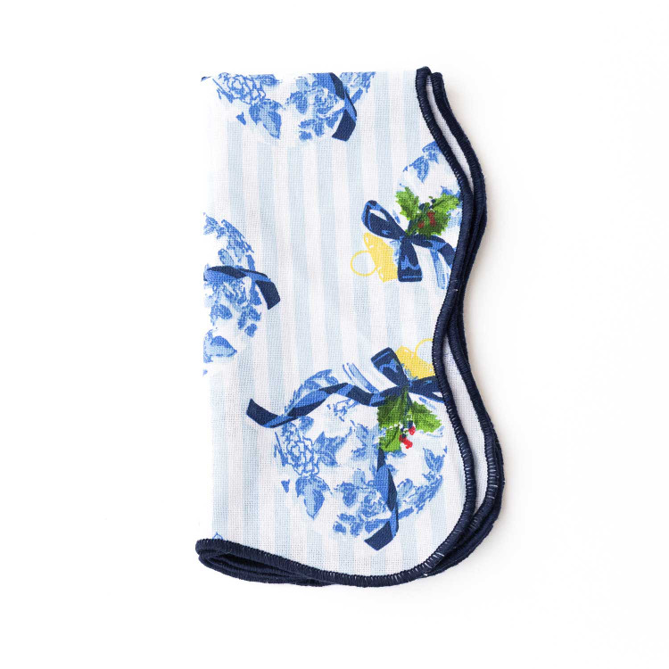 Holiday Chinoiserie scalloped dinner napkin with a blue floral and bow print