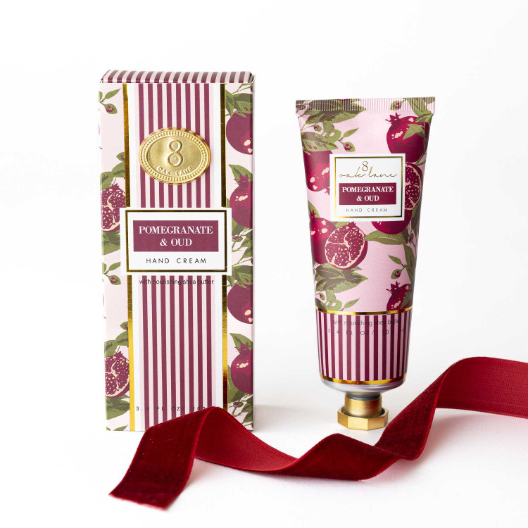 Pomegranate & Oud hand cream box and tube in a striped pink pomegranate print