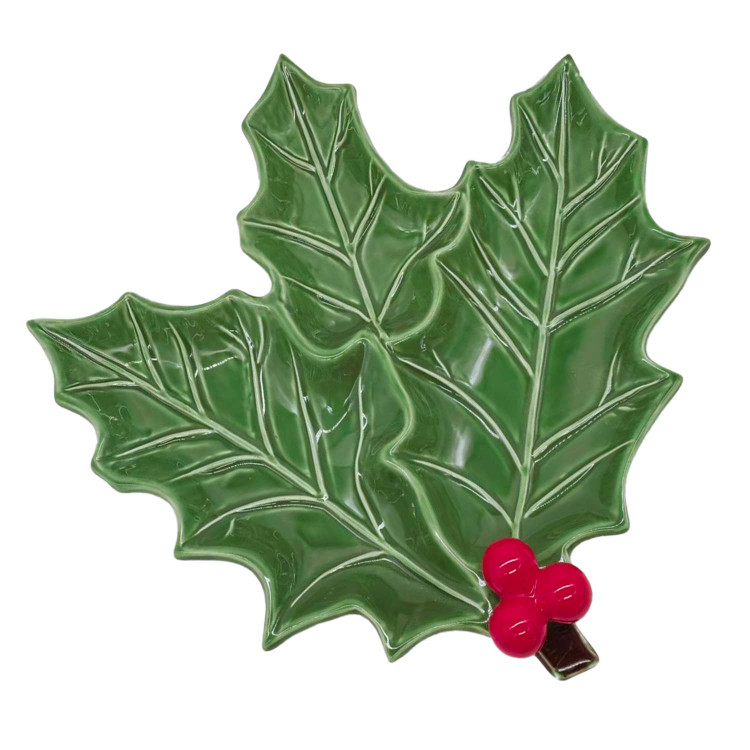 Glossy green ceramic serving platter shaped like a holly leaf with a red berry cluster accent