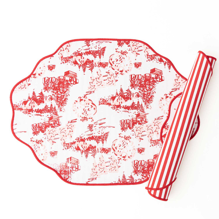 Santa Toile reversible scalloped placemat with a red village toile print and red striped reverse side