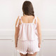 Back view of women’s cotton pajama set in pink striped textured fabric with smocked top and drawstring shorts