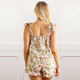 Back view of women’s cotton pajama set in botanical berry print with smocked top and drawstring shorts