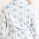 Close-up of blue rose vine floral robe fabric with soft plush texture and tie waist detail