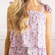 Close-up of lilac floral cotton pajama top with smocking and adjustable bow tie straps