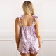 Back view of women’s cotton pajama set in lilac floral print with smocked top and drawstring shorts