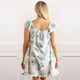 Back view of women’s floral cotton sleep dress with cap sleeves, relaxed fit and ruffle hem