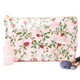 8 Oak Lane berry botanical clear coated travel cosmetic case with pink floral print and zipper closure (front view)