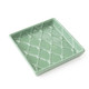 Green textured beverage napkin tray with glossy finish and decorative design (top view)