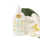 8 Oak Lane magnolia fig hand and body lotion in mint bottle with soft green botanical pattern (front view)