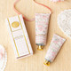 Flat lay of vanilla blush hand cream with pastel pink packaging and matching tube detail